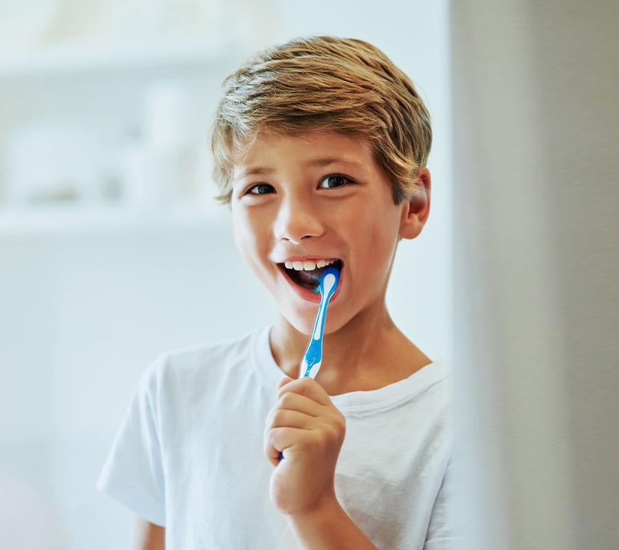 Brushing teeth at Smile Arc Pediatric Dentistry in San Diego, CA